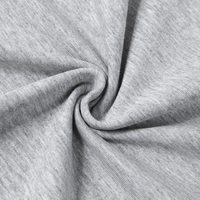 A close-up of light heather gray fabric arranged in a spiral drape to show texture and flexibility.